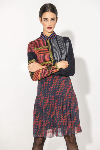 Mini tiered skirt with dots with shirt arms crossed • Sassa Björg