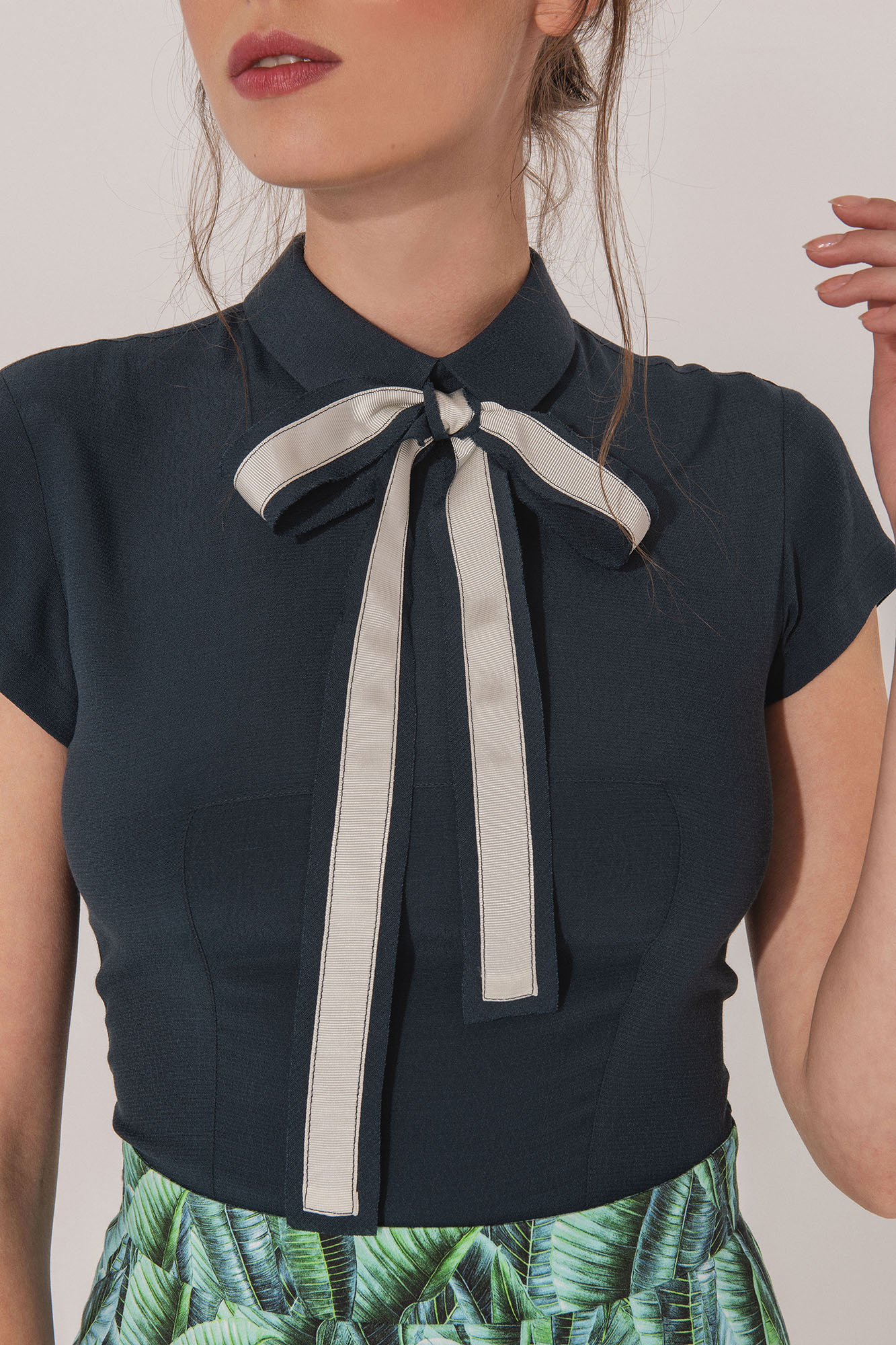 Petrol blue shirt with back buttons and a bow close up • Sassa Björg