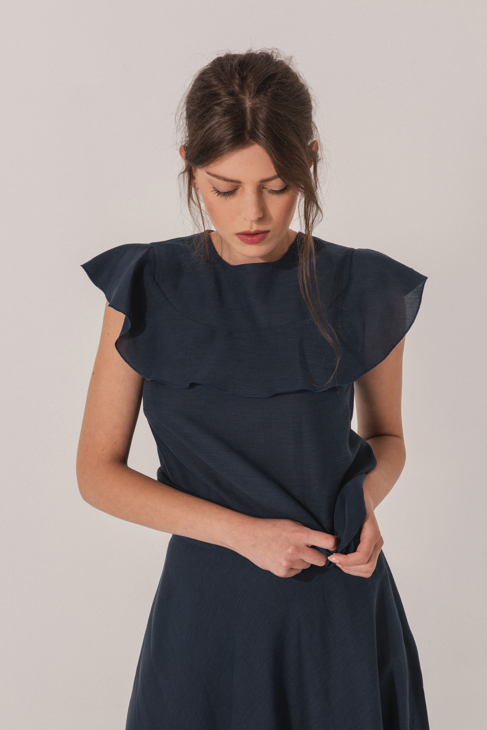 Navy blue linen blouse with a ruffle close up scaled • Sassa Björg